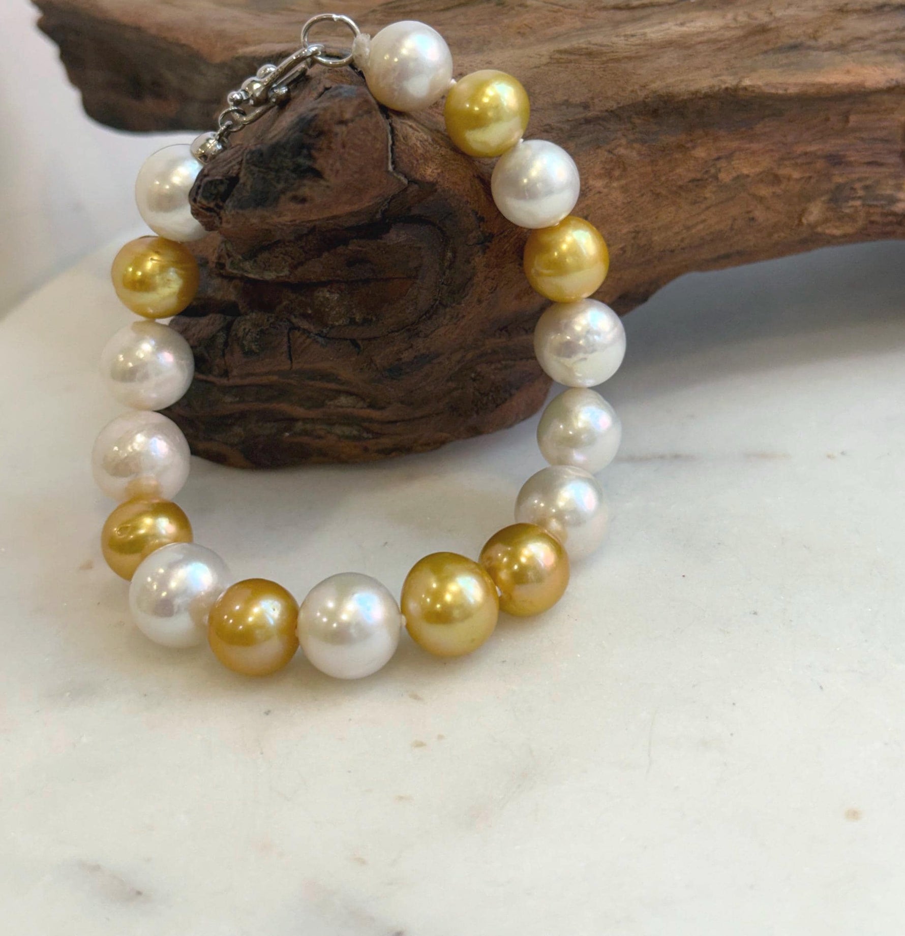 Elly’s 17pcs 10.2-11.5mm White golden Edison Pearls Bracelet: Extreme luster mirrored, 8.3” knotted, S925 silver Bracelet.