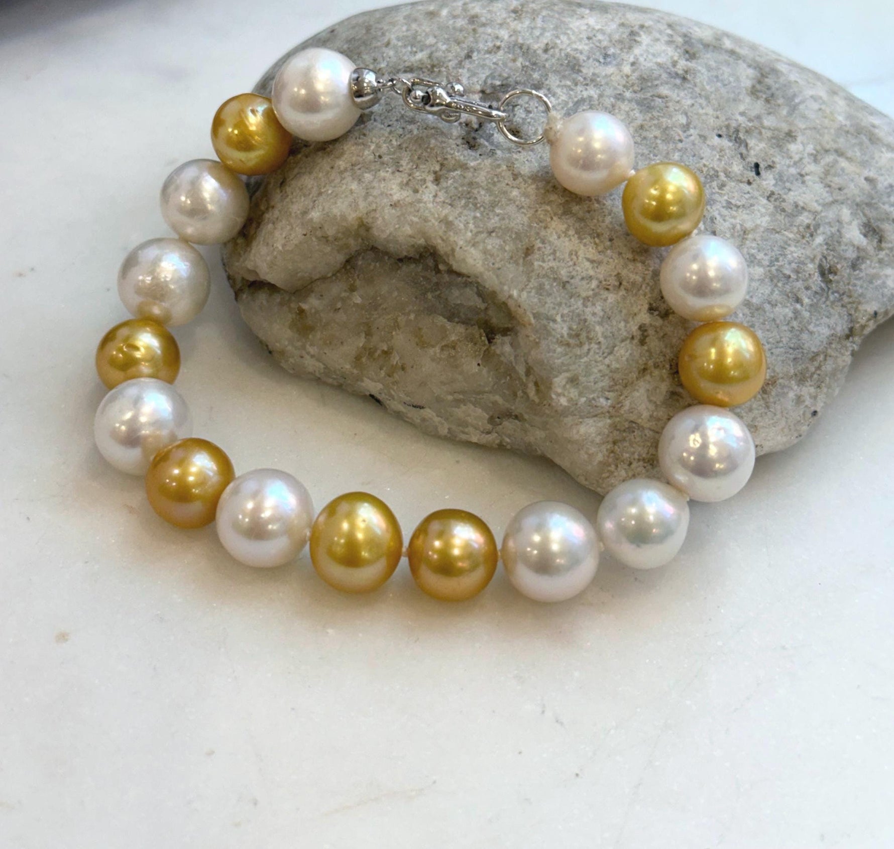 Elly’s 17pcs 10.2-11.5mm White golden Edison Pearls Bracelet: Extreme luster mirrored, 8.3” knotted, S925 silver Bracelet.