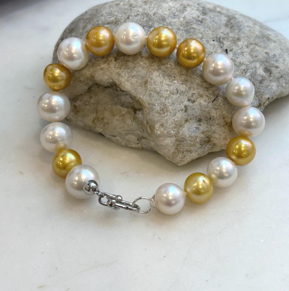 Elly’s 17pcs 10.2-11.5mm White golden Edison Pearls Bracelet: Extreme luster mirrored, 8.3” knotted, S925 silver Bracelet.