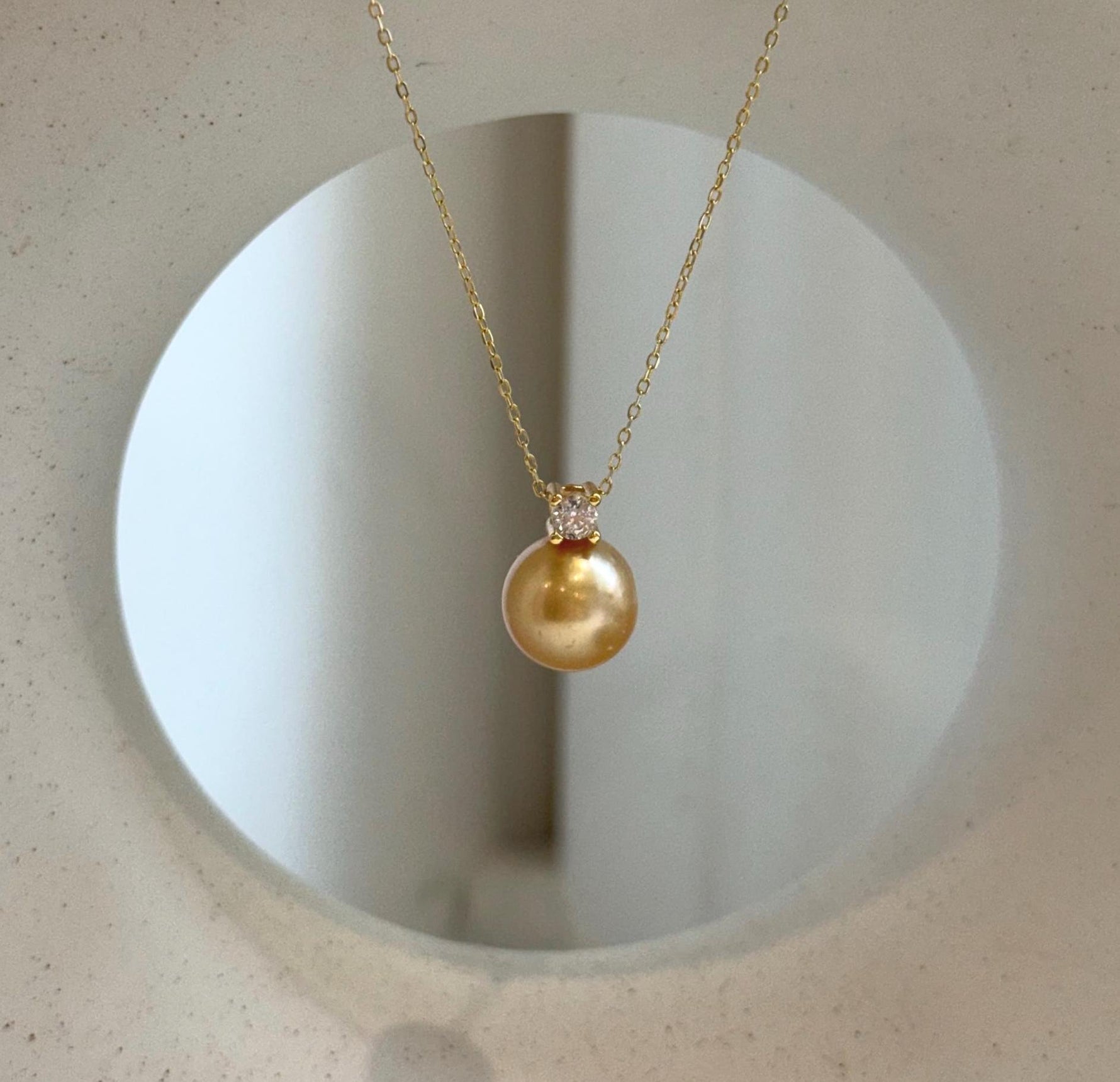 Elly’s 10.9mm South Sea deep tea Gold ocean Pearl pendant: Extreme luster mirrored, 1.5cm high, S925 silver w/ gold plated pendant.