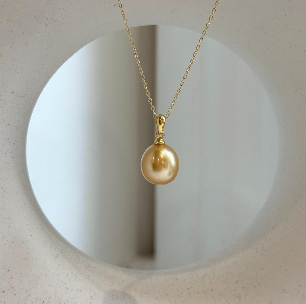 Elly’s 10.6mm South Sea deep tea Gold ocean Pearl pendant: Extreme luster mirrored, 1.9cm high, S925 silver w/ gold plated pendant.