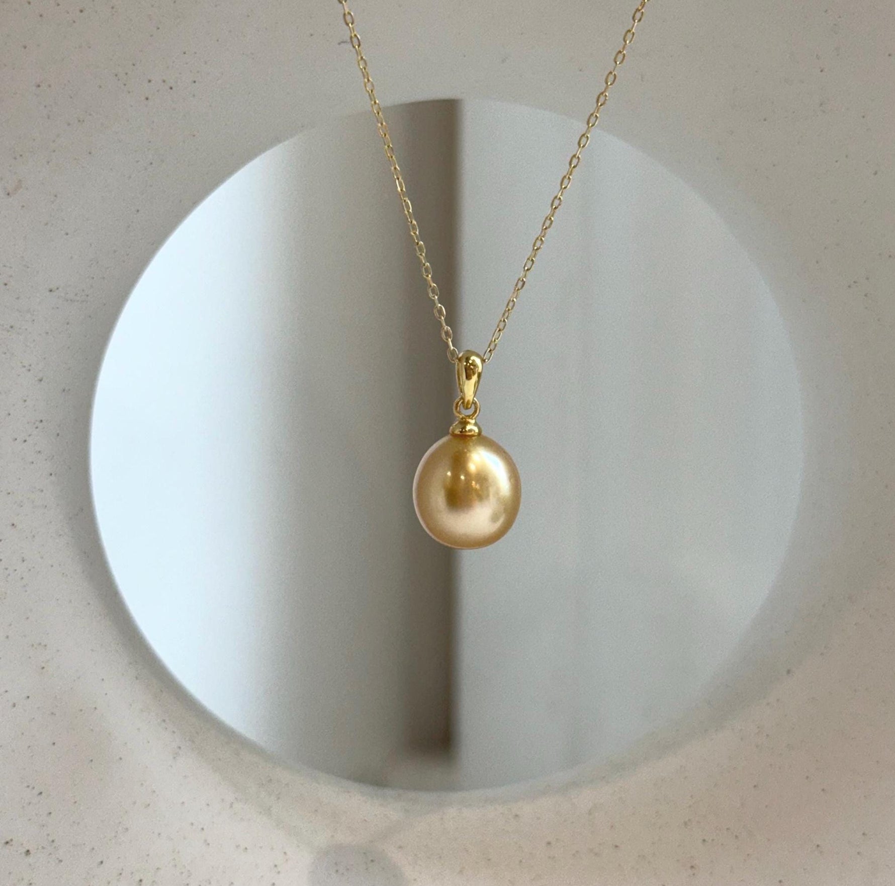 Elly’s 10.6mm South Sea deep tea Gold ocean Pearl pendant: Extreme luster mirrored, 1.9cm high, S925 silver w/ gold plated pendant.