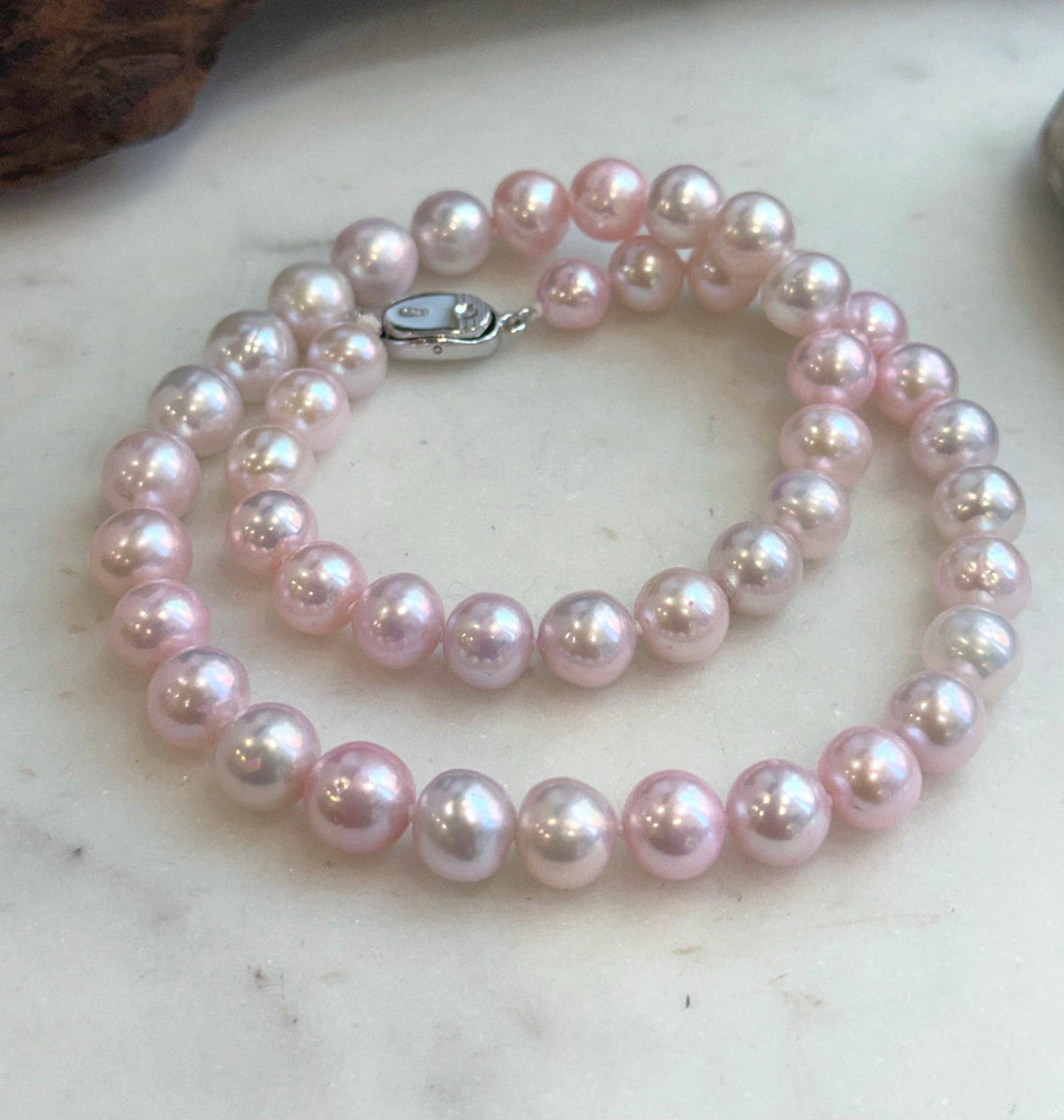 High-luster pale pink pearl strand showing natural pearl surface