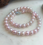 High-luster pale pink pearl strand showing natural pearl surface