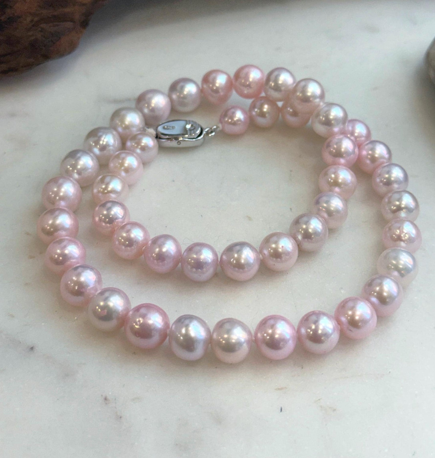 High-luster pale pink pearl strand showing natural pearl surface