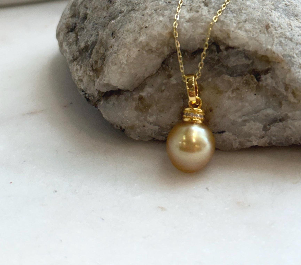 Real South Sea pearl pendant featuring a 10.4mm natural ocean pearl with brilliant mirror luster and sterling silver hardware.
