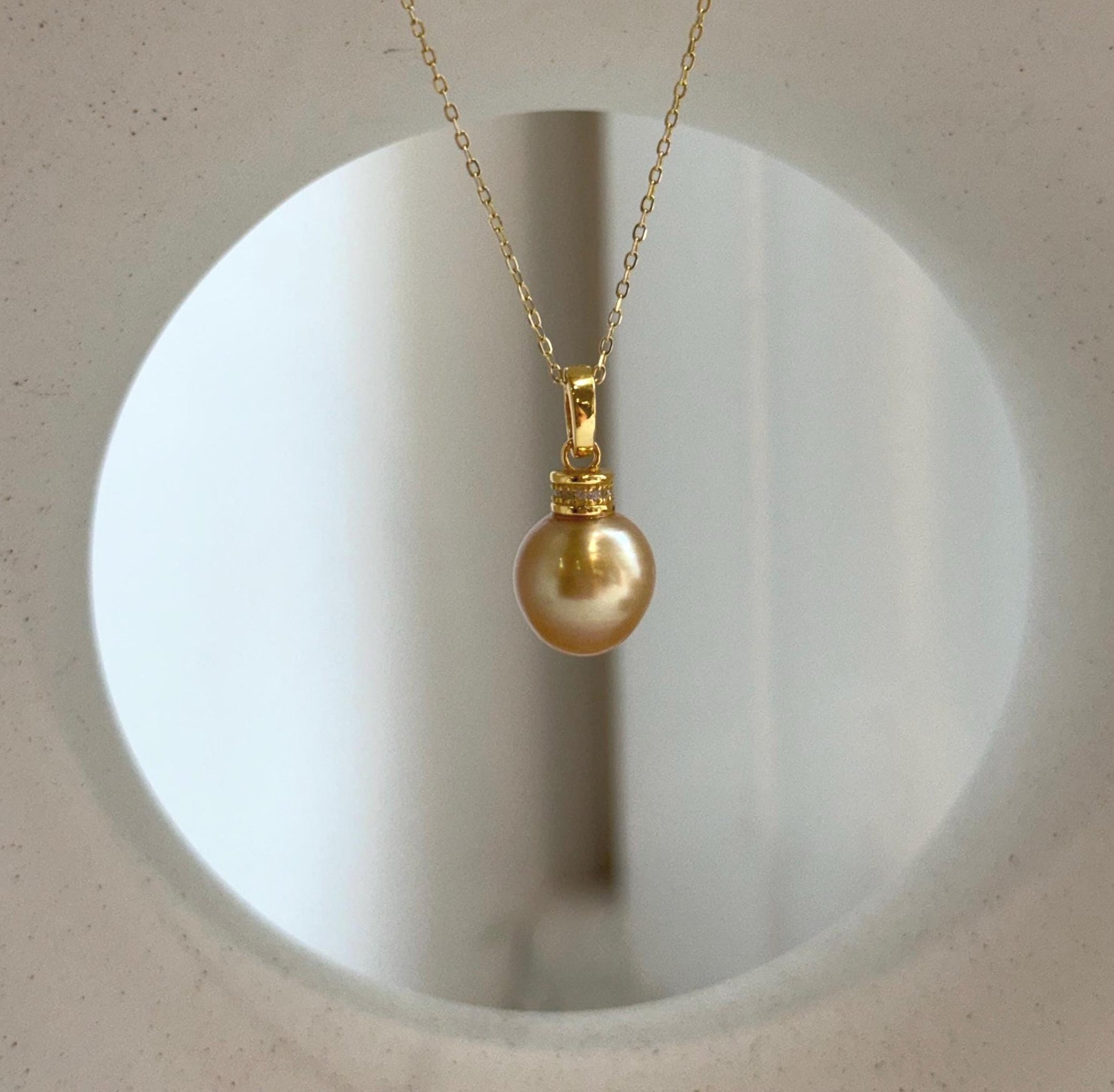 Round South Sea ocean pearl pendant in natural deep tea gold color with exceptional mirror luster and polished S925 silver bail.