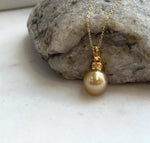 Luxury genuine South Sea pearl necklace pendant with a 10.4mm deep tea gold pearl, mirror shine, and sterling silver setting.