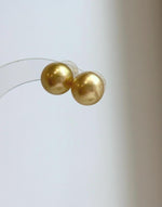 Handmade genuine pearl stud earrings featuring 11.6mm South Sea pearls.