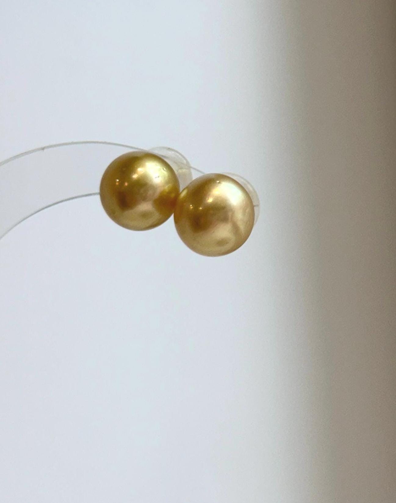 Handmade genuine pearl stud earrings featuring 11.6mm South Sea pearls.