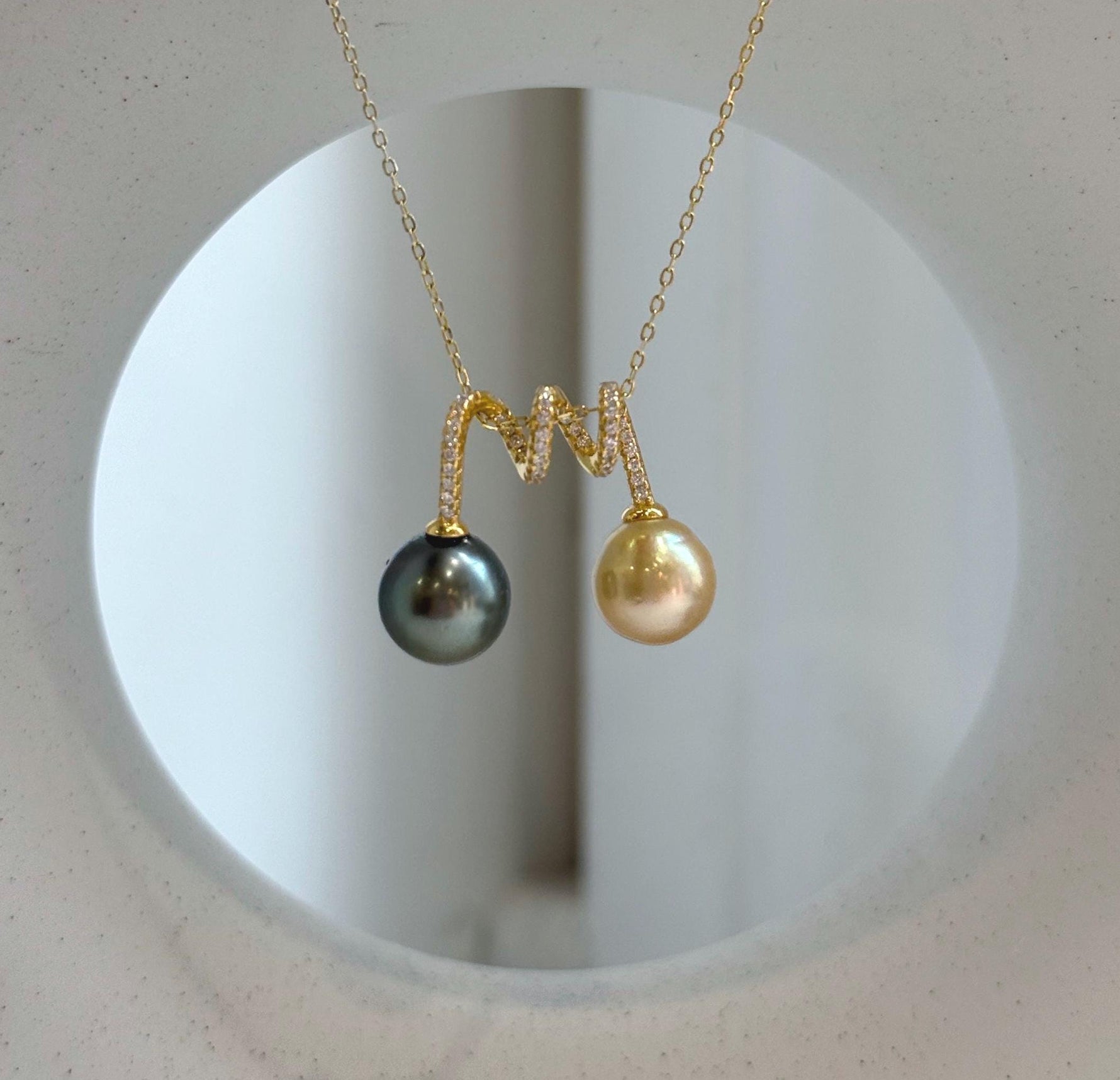 Elegant S925 silver pendant with genuine South Sea and Tahitian pearls.