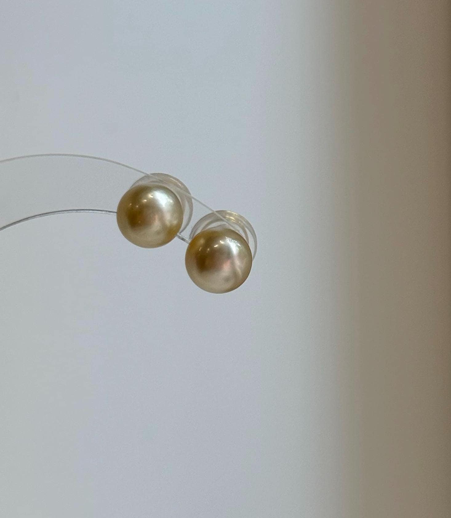 Natural 9mm deep gold South Sea pearl stud earrings with mirror luster.