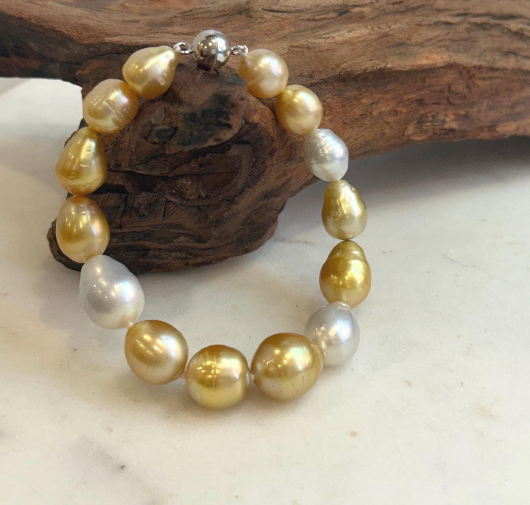 Natural golden and white pearls on silver bracelet.