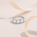 Elegant minimalist five stone moissanite ring.