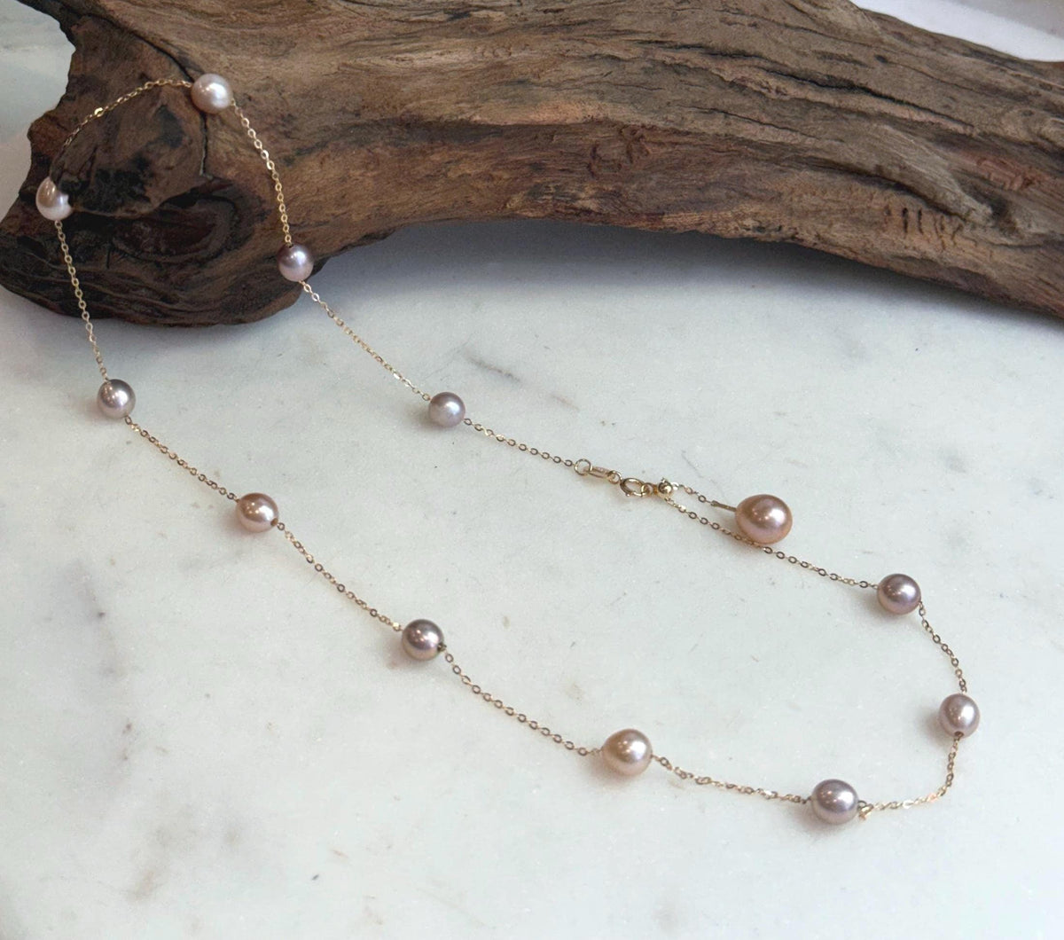 Minimalist layered pearl necklace featuring Akoya saltwater pearl pendant and Keshi pearl chain.