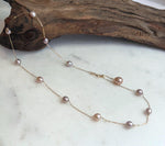 Minimalist layered pearl necklace featuring Akoya saltwater pearl pendant and Keshi pearl chain.