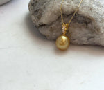 Natural South Sea golden pearl pendant featuring a 10.2mm deep gold ocean pearl with exceptional shine.