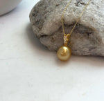 Minimalist South Sea pearl pendant with premium 10.2mm deep golden pearl and elegant sterling silver bail.