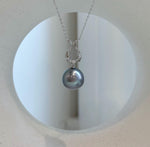 Luxury Tahitian pearl pendant with iridescent platinum pearl and sterling silver setting.