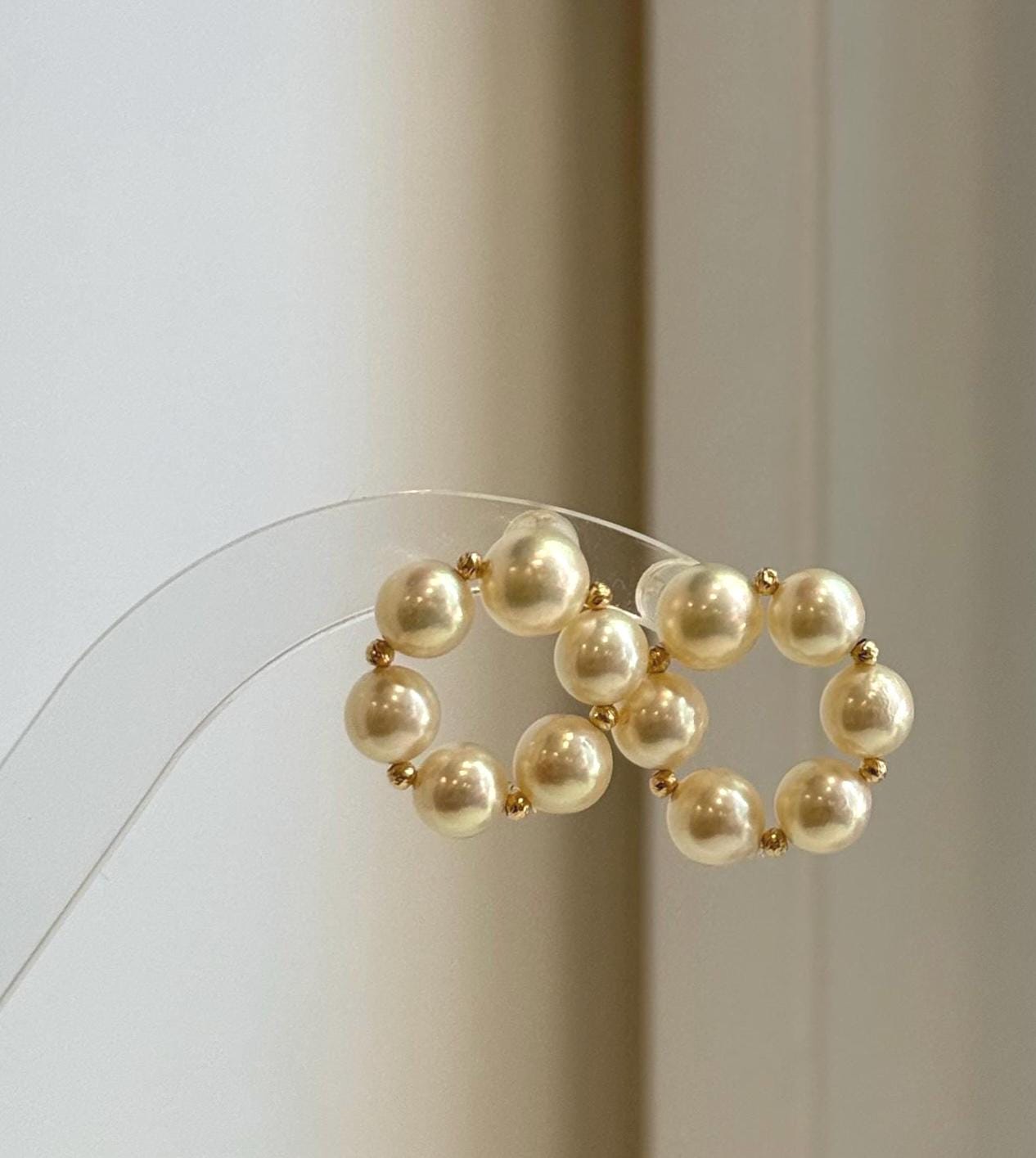 Elly’s 18K gold Akoya pearl donut stud earrings with 6.6–7.6mm genuine golden saltwater pearls and mirror luster.