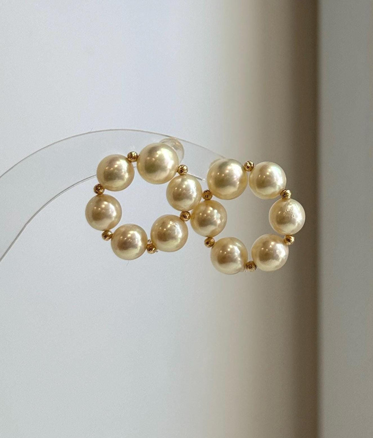 Premium 18K gold Akoya pearl earrings featuring naturally golden ocean pearls with high luster.
