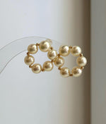 Premium 18K gold Akoya pearl earrings featuring naturally golden ocean pearls with high luster.