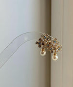 Elegant floral pearl stud earrings crafted with genuine Japanese Akoya pearls.