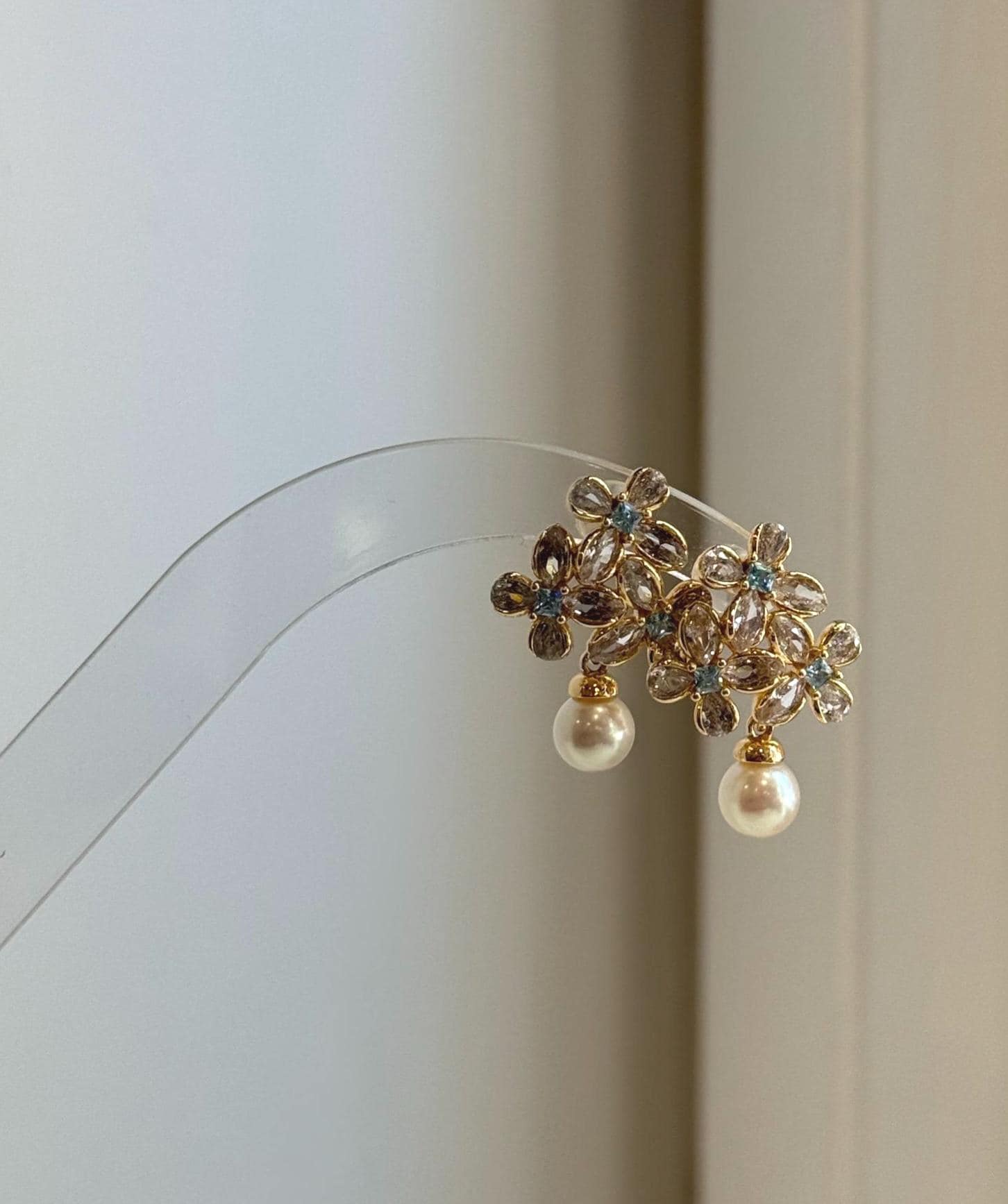 Elegant floral pearl stud earrings crafted with genuine Japanese Akoya pearls.