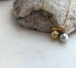 Genuine deep golden South Sea pearl paired with platinum blue Tahitian pearl.