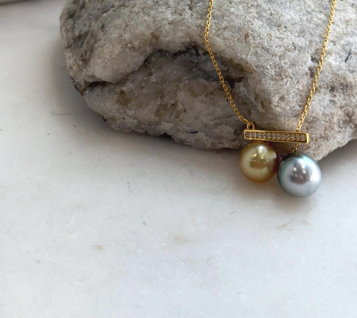 Genuine deep golden South Sea pearl paired with platinum blue Tahitian pearl.