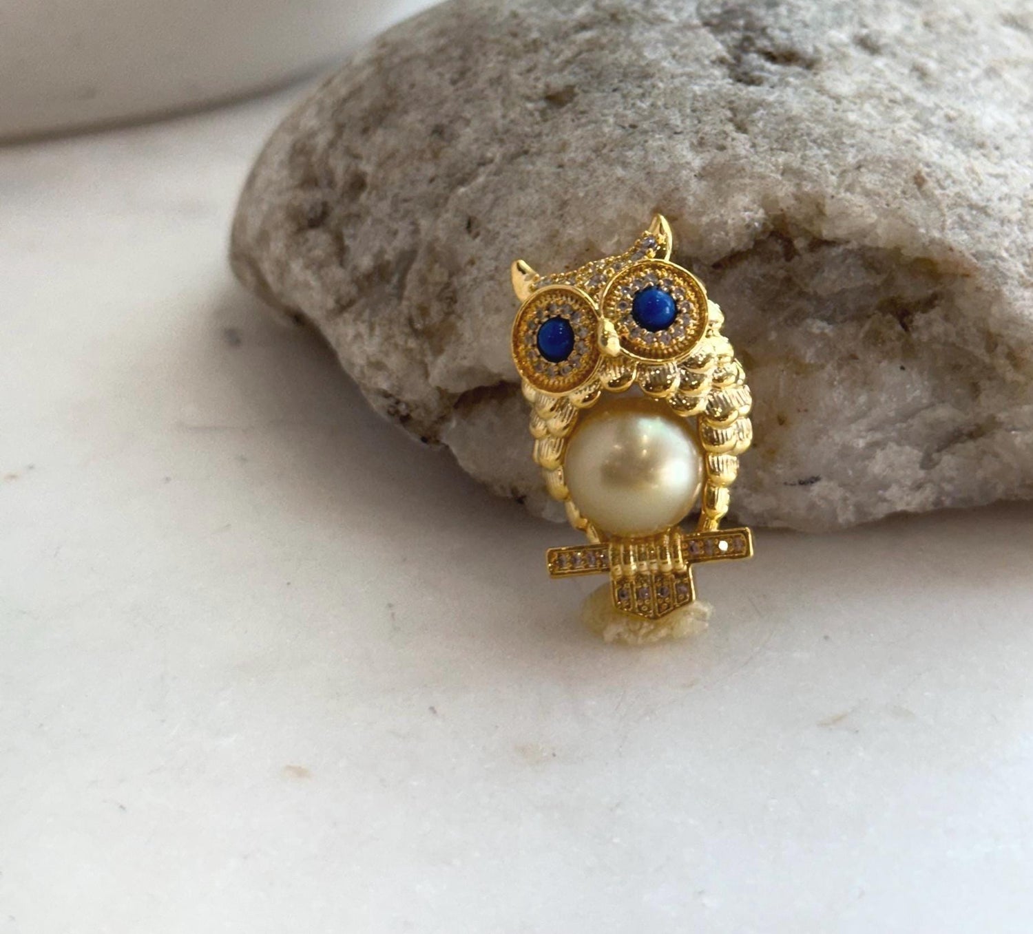 Deep golden South Sea pearl owl pin with mirror-like luster.
