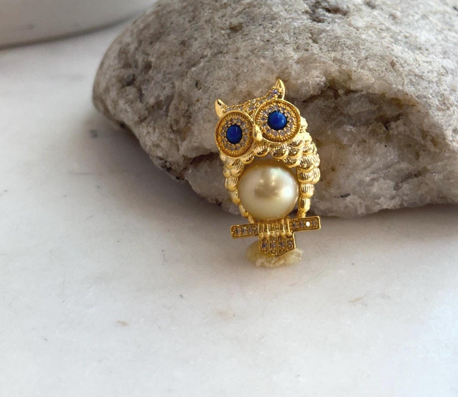 Elegant owl brooch featuring a genuine South Sea pearl.