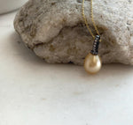 Minimalist sterling silver pendant showcasing a natural 9.7mm golden South Sea pearl.