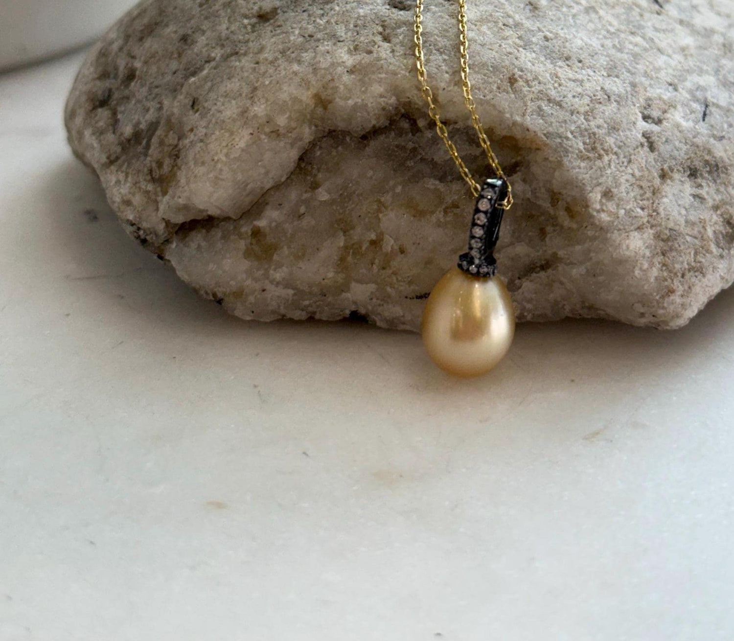 Natural golden South Sea saltwater pearl pendant featuring rich deep tea gold color.