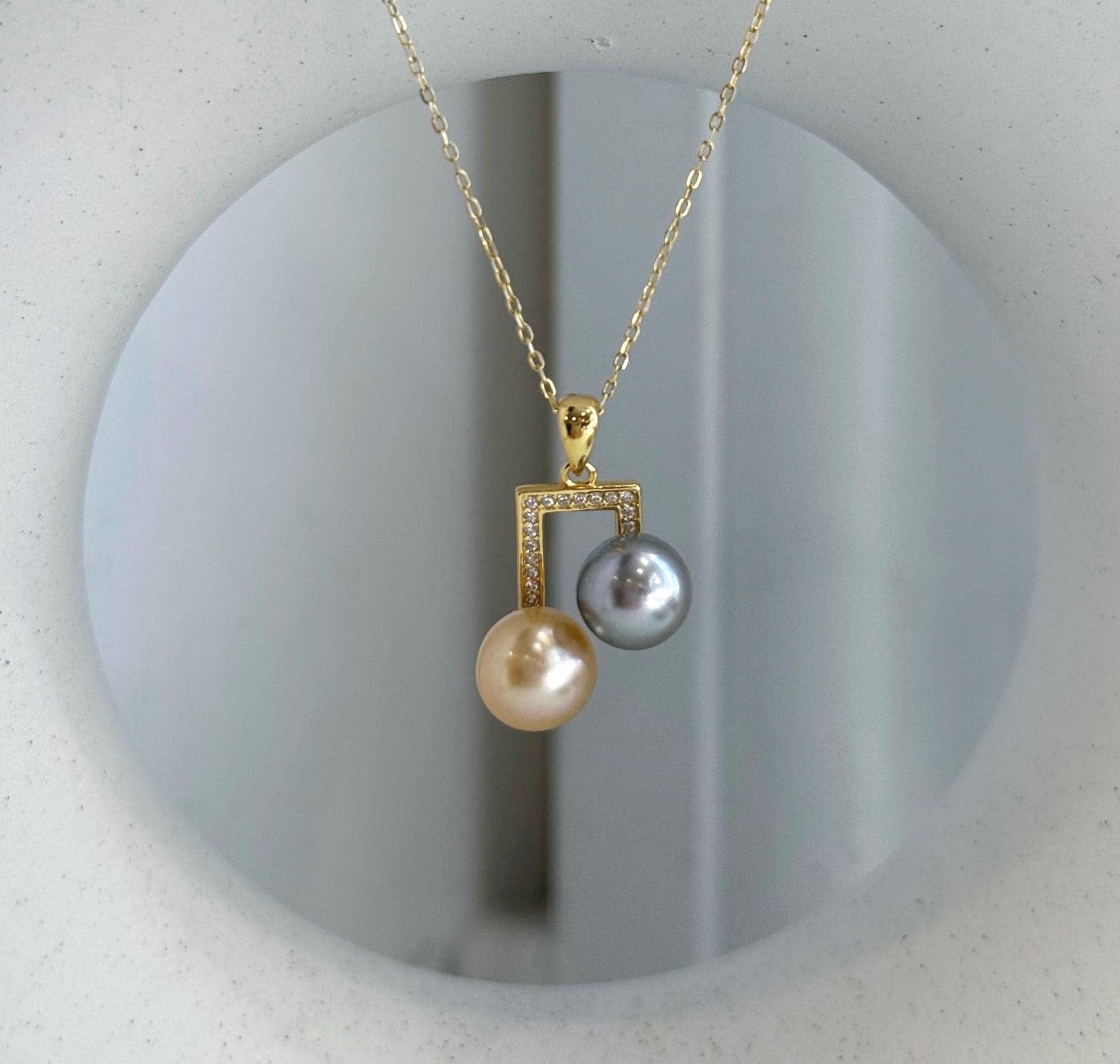 Double South Sea Golden and Tahitian pearl pendant with mirror luster in S925 sterling silver.