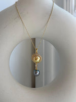 Genuine South Sea Golden pearl paired with a Tahitian pearl in an elegant sterling silver pendant.