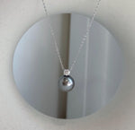 Luxury Tahitian pearl pendant featuring sparkling moissanite accent.