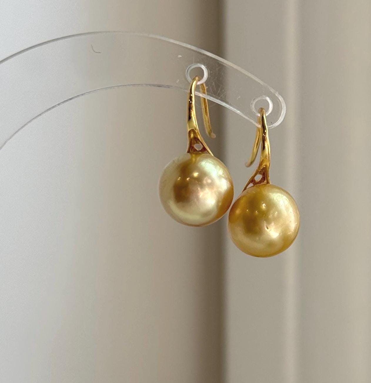 Premium 11mm South Sea golden pearl earrings with exceptional shine.