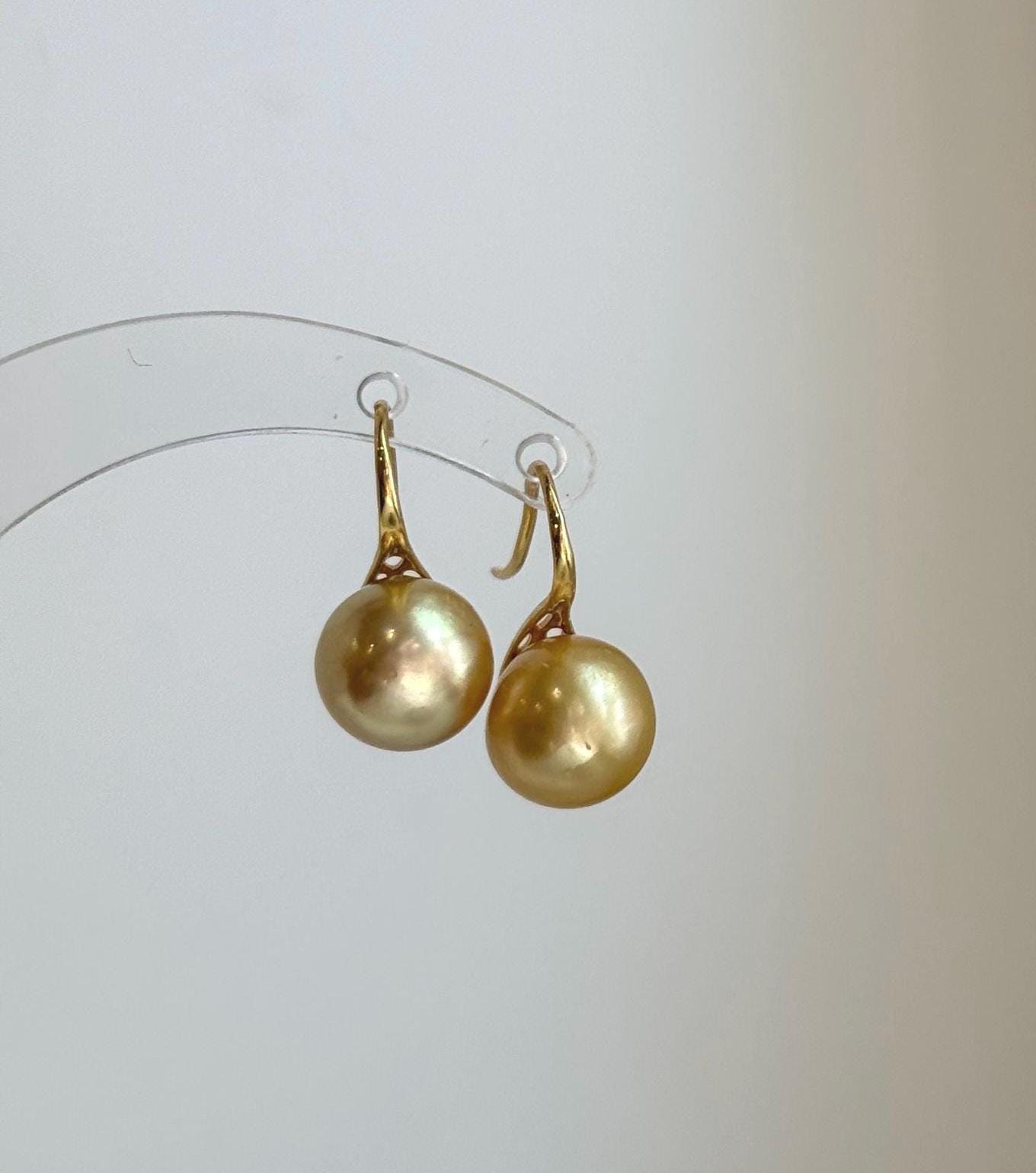 Genuine 11mm South Sea golden pearl high heel hook earrings with mirror luster.