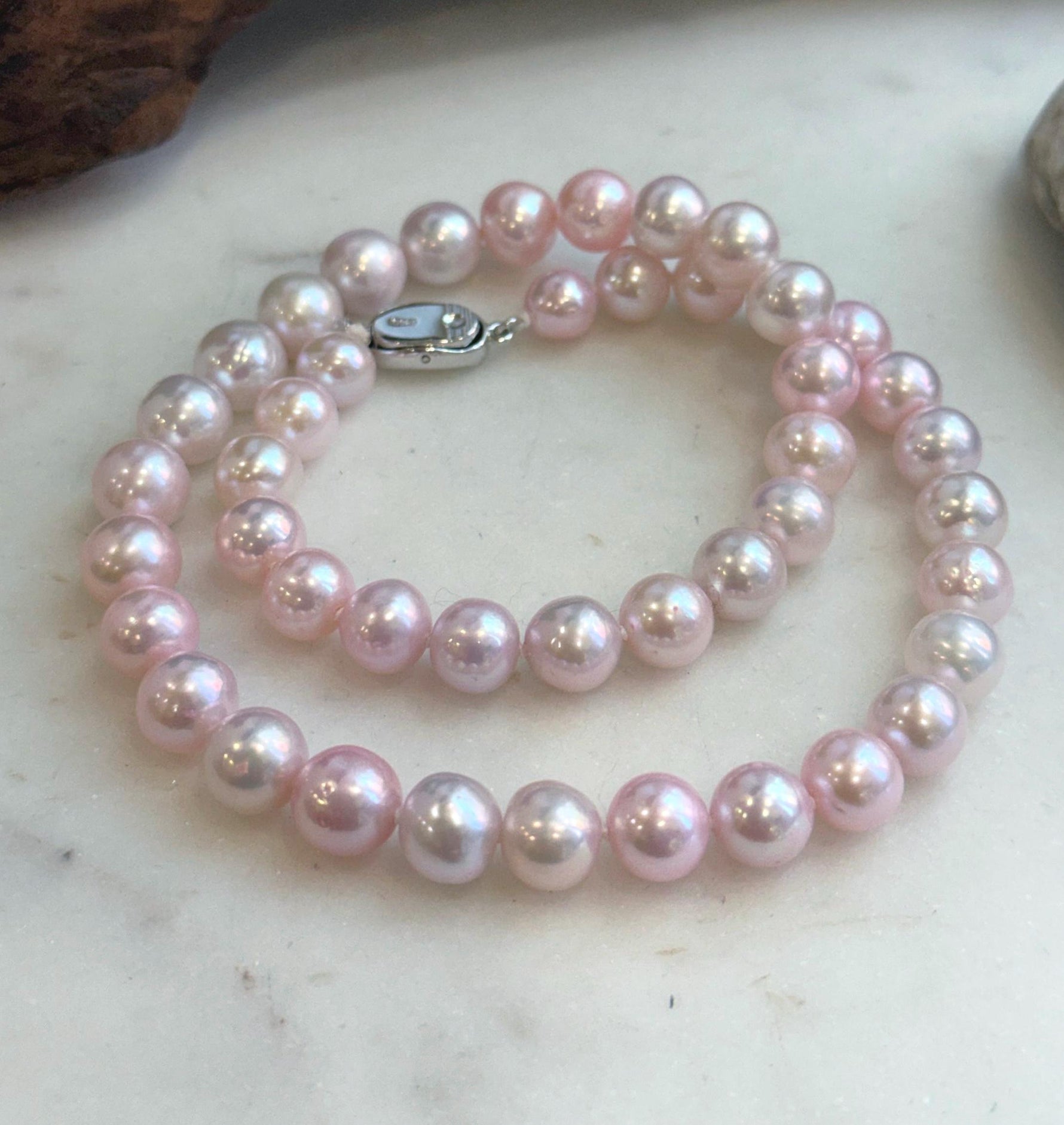 lustrous pale pink genuine pearls with smooth round shape