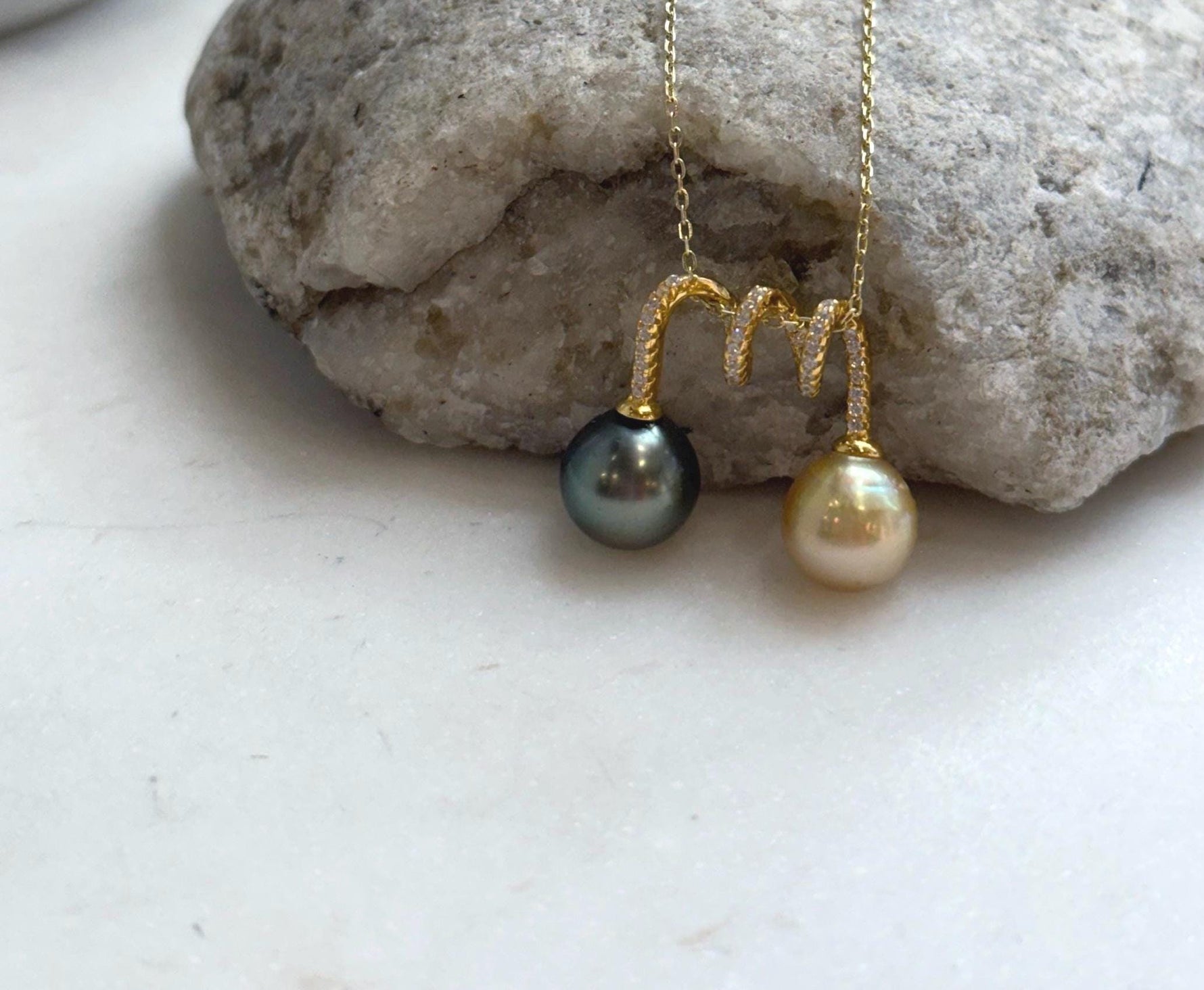 Natural golden South Sea pearl paired with a Tahitian pearl pendant.