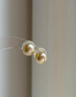 Genuine ocean gold pearls with smooth round shape and high luster.