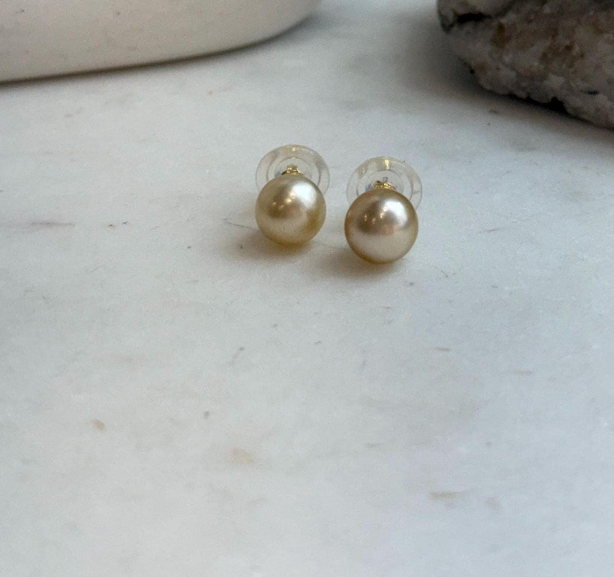 Genuine ocean gold pearls with smooth round shape and high luster.
