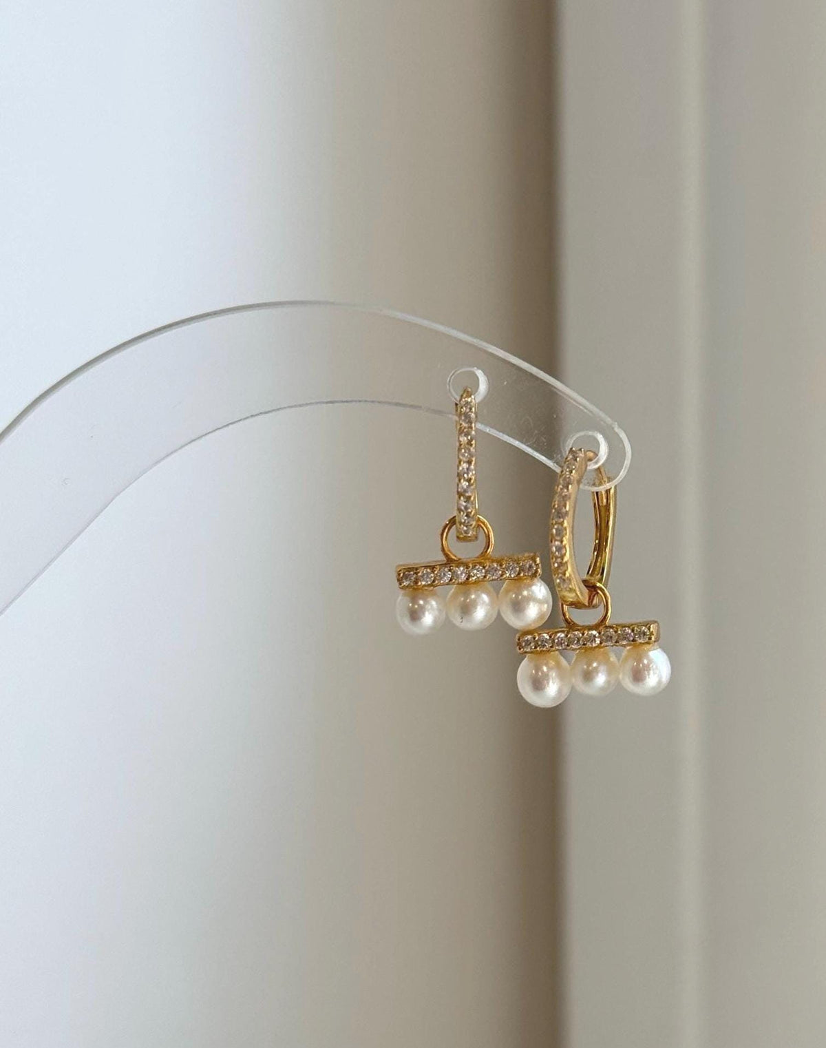 Small pearl hoop earrings featuring 4-4.4mm natural freshwater pearls.