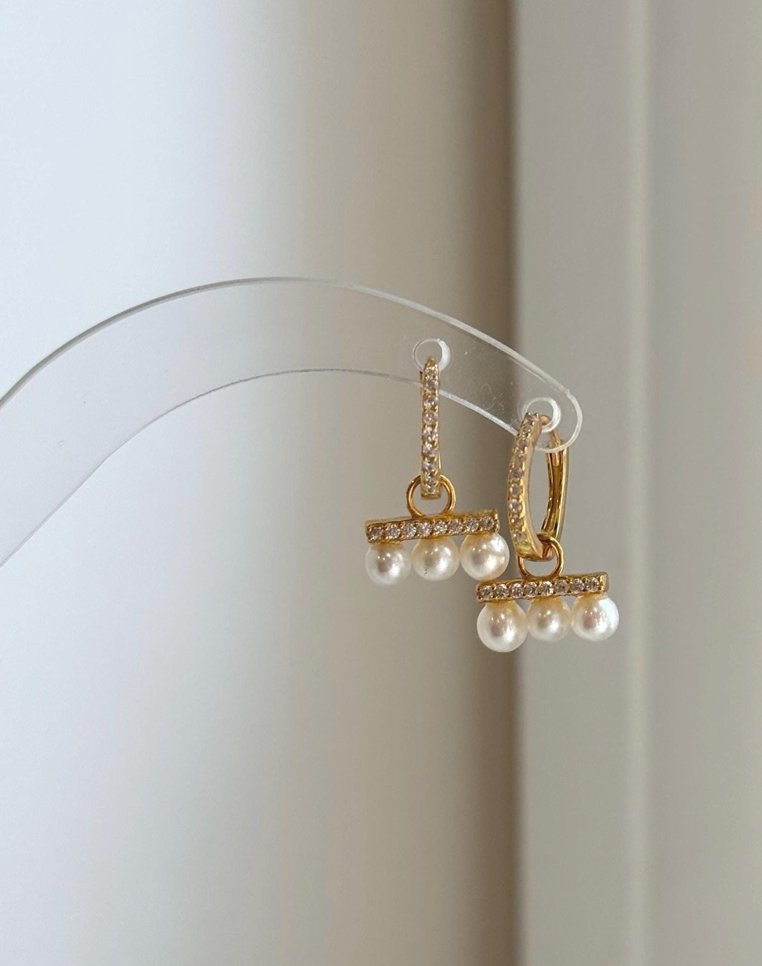 Small pearl hoop earrings featuring 4-4.4mm natural freshwater pearls.