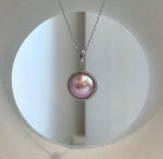 Genuine Mabe pearl earrings with matching pendant necklace.