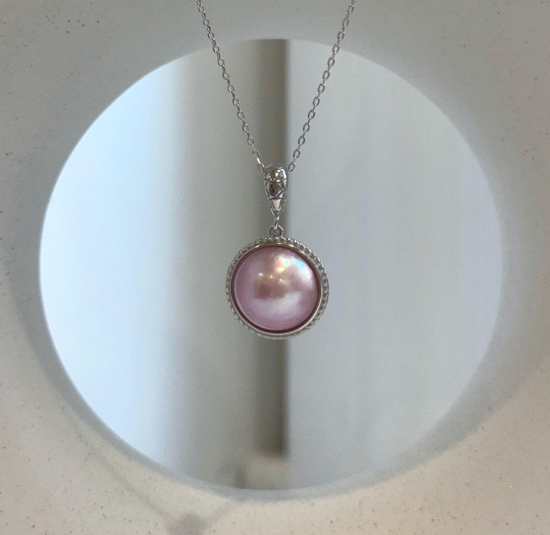 Genuine Mabe pearl earrings with matching pendant necklace.