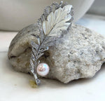 Mirror-luster 9.7mm Edison pearl set on an elegant leather brooch.
