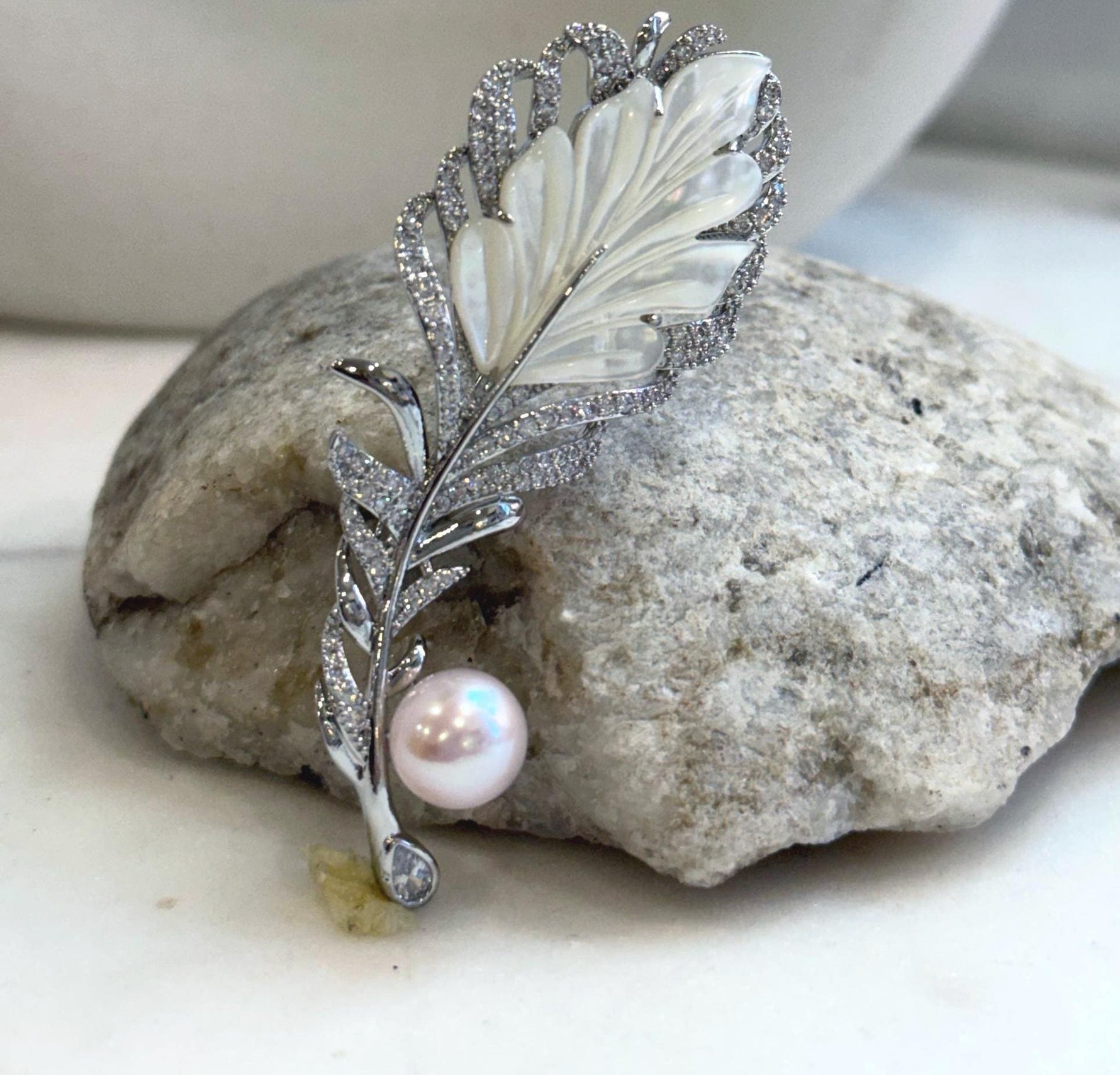 Mirror-luster 9.7mm Edison pearl set on an elegant leather brooch.