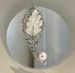 Genuine Edison pearl brooch featuring a soft pale pink pearl and leather design.